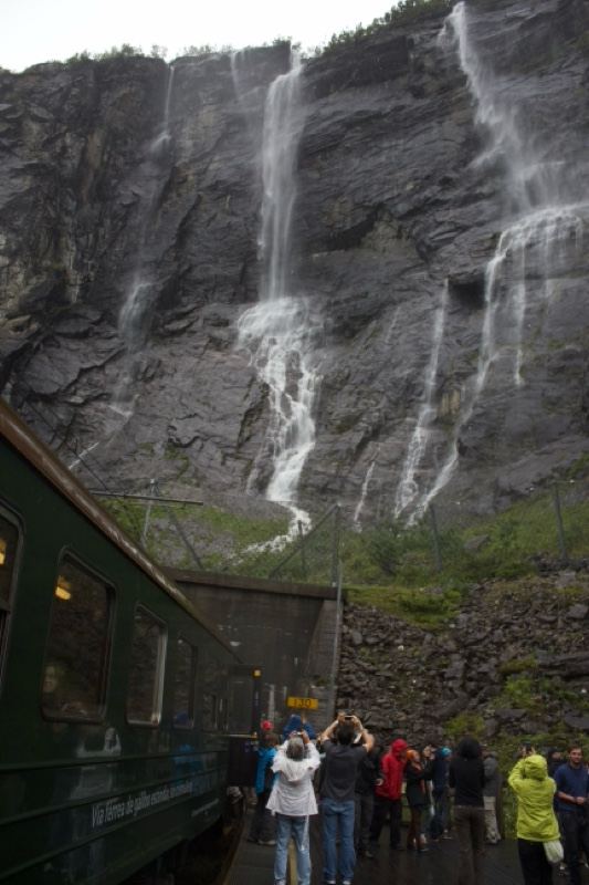Train at waterfall cliff
