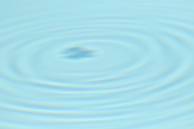 Concentric Ripples on Calm Blue Water