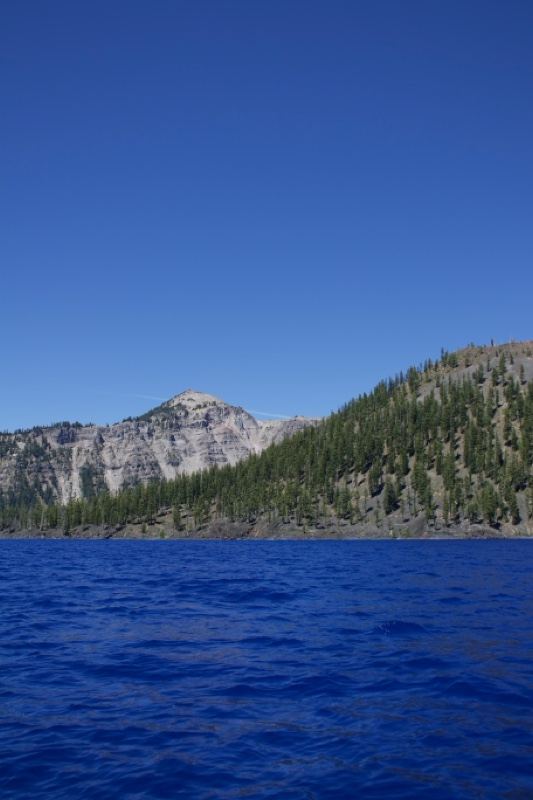 Crater Lake with Forested Hill and Mountains