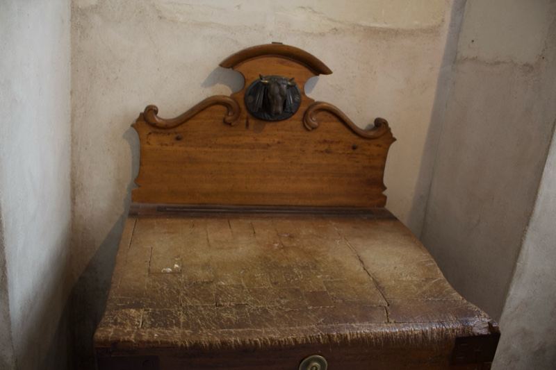 Antique wooden bed with carved headboard