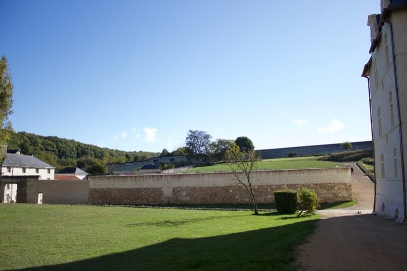Sunny courtyard enclosed by stone walls
