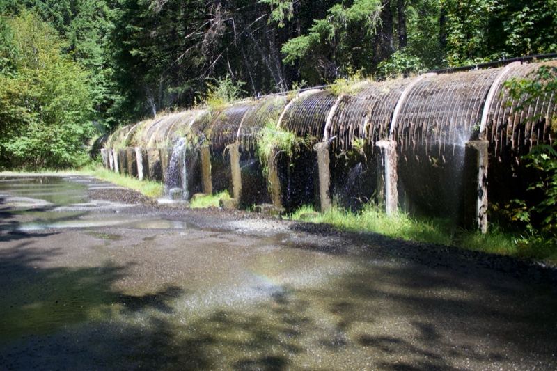 Water flowing over arched metal pipe
