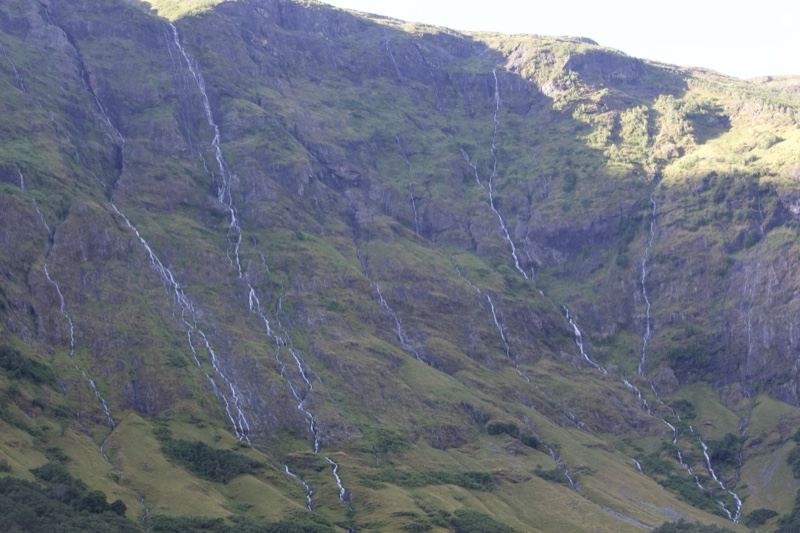 Sunlit Mountain With Cascading Waterfalls