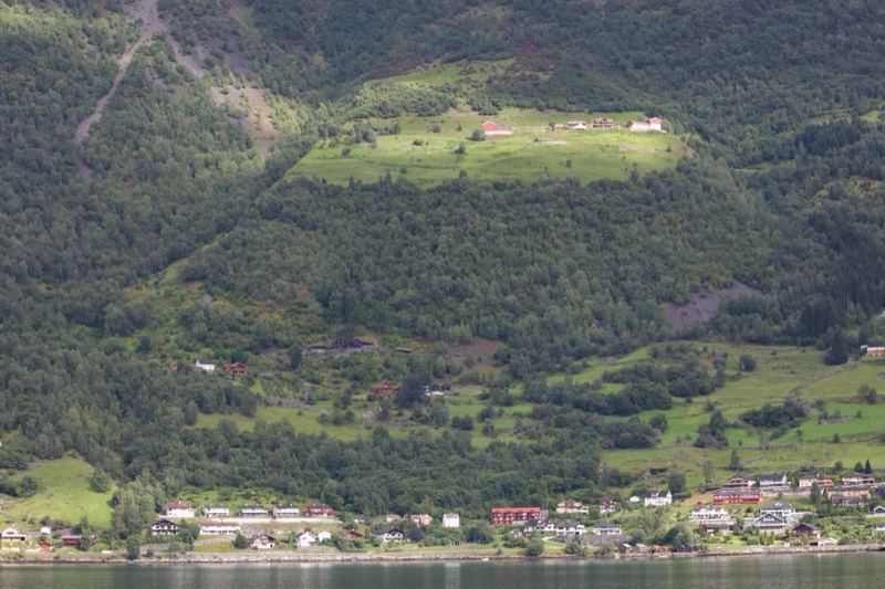 Mountain Village Nestled in Green Fjord Valley