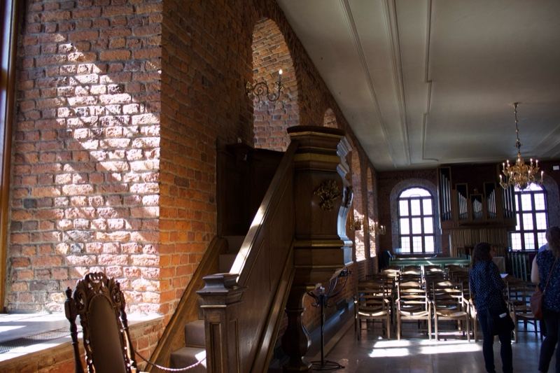 Interior Hall With Brick Walls And Balcony