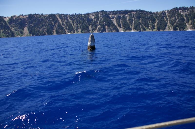 Buoy on Crater Lake with cliffs