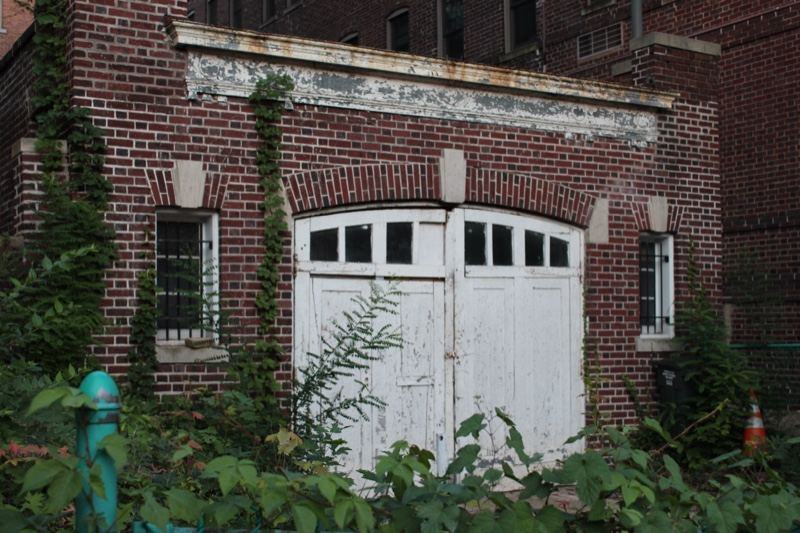 Abandoned Brick Garage With Overgrowth