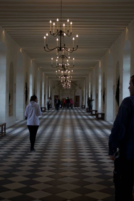 Grand Hallway with Chandeliers and Checkered Floor