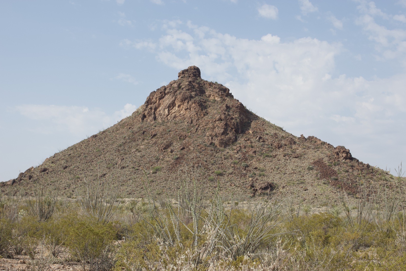 Desert Butte Under Partly Cloudy Sky