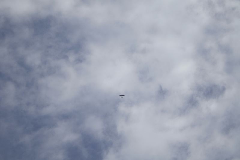 Airplane Flying Through Cloudy Sky