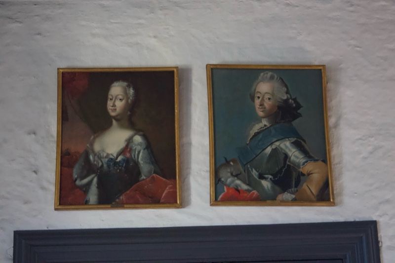 Two framed royal portraits on wall