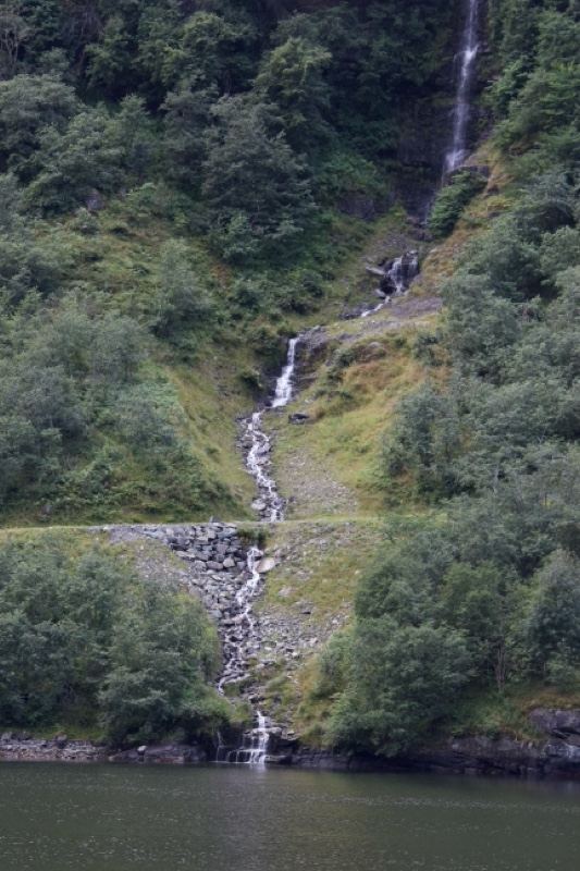 Waterfall Cascading Into Fjord Lake
