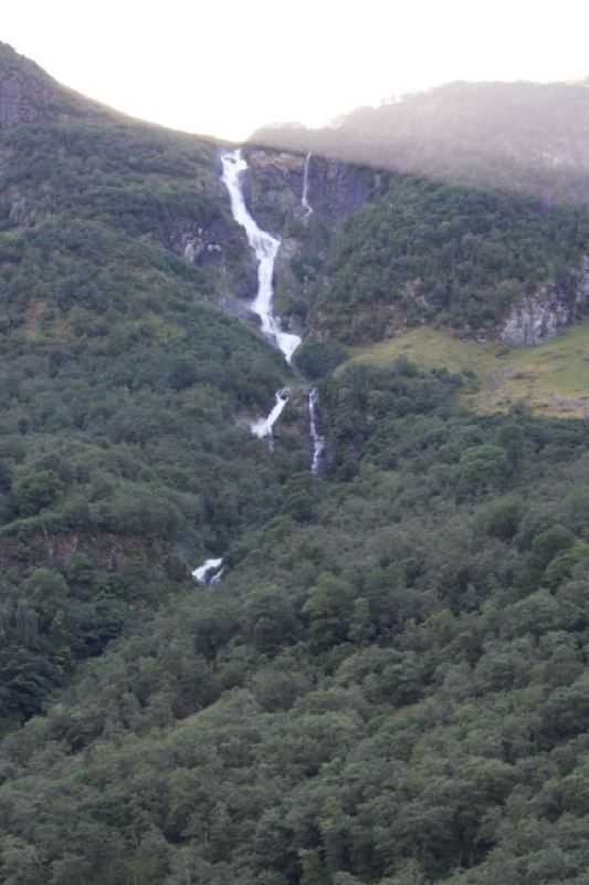 Mountain Waterfall Cascading Through Forest