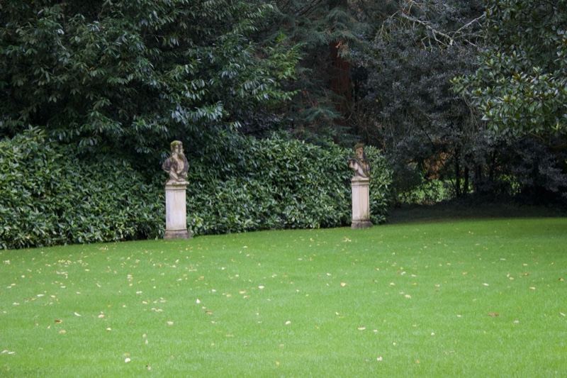 Manicured lawn with statues in garden