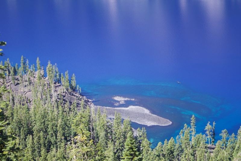 Deep Blue Alpine Lake with Forest Shore