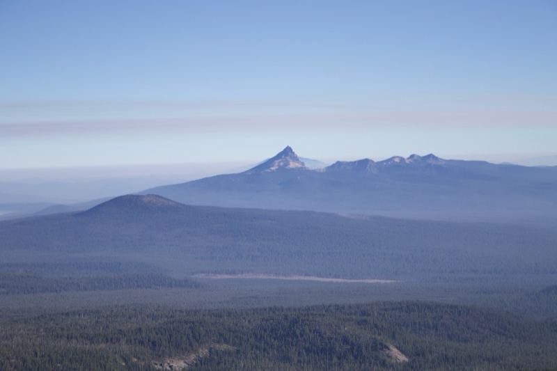 Distant Snow-Capped Mountain Over Forest