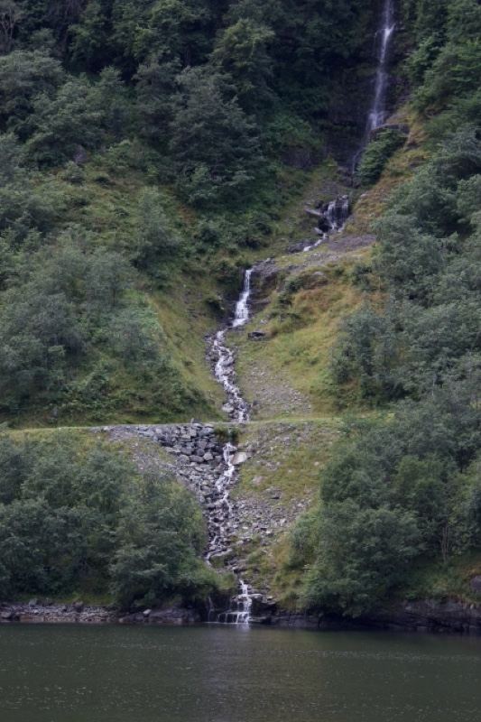 Waterfall Cascading Into Fjord Lake