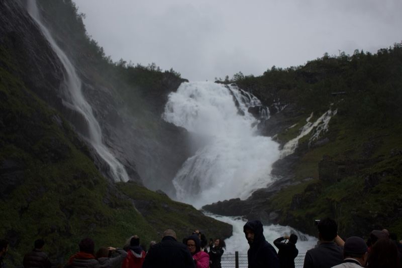 Tourists Watching Mountain Waterfall