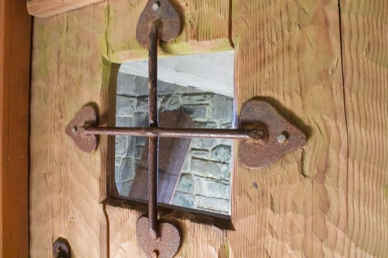 Rustic wooden door with cross latch window