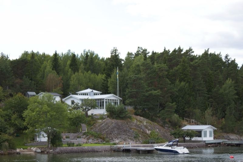 White House on Forested Lake Shore