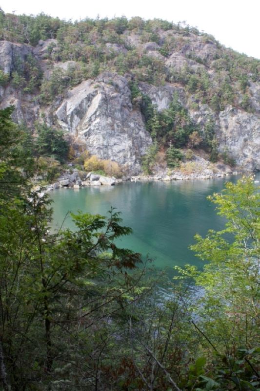 Turquoise Lake Below Rocky Cliffs