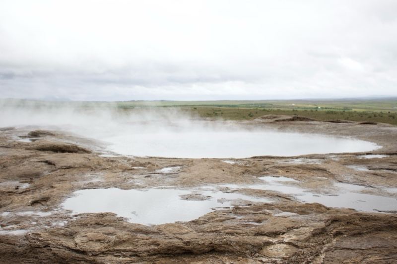 Steaming Geothermal Pool in Overcast Landscape