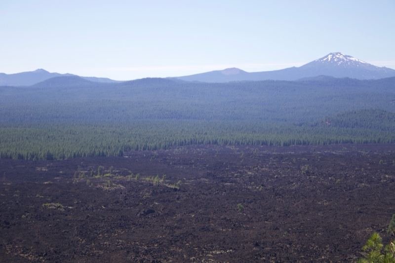 Volcanic Lava Field With Distant Mountains