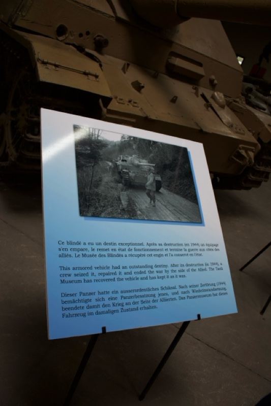 Museum tank exhibit with informational plaque
