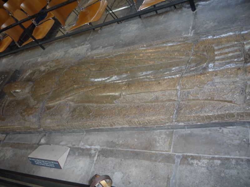 Medieval stone effigy on church wall