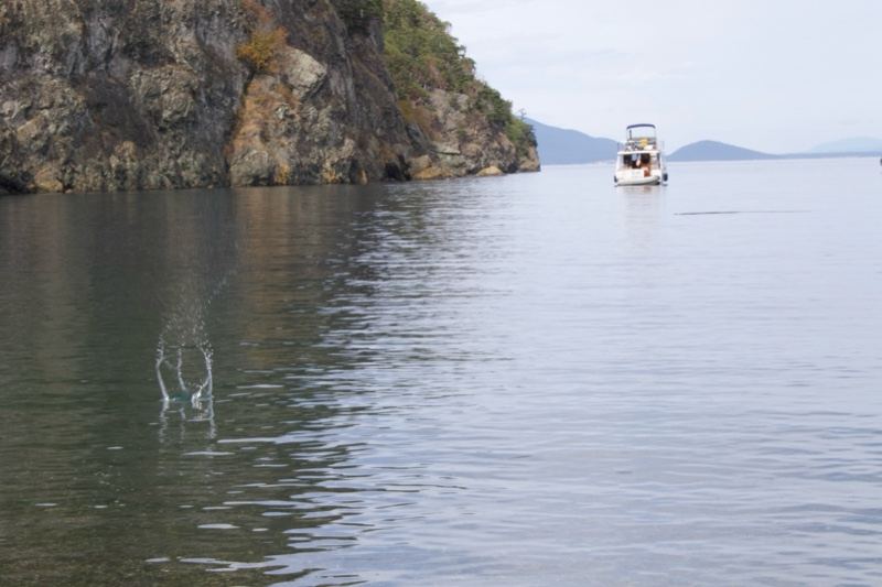Boat on Calm Lake Near Rocky Cliff