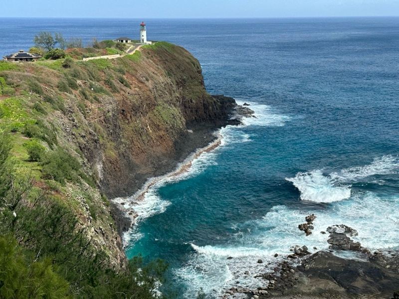 Lighthouse on Coastal Cliff Over Ocean