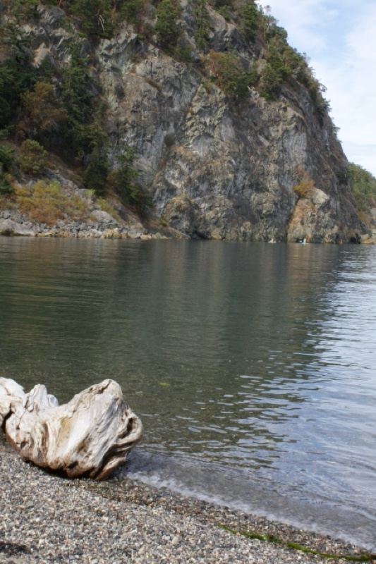 Rocky Cliff Over Calm Lake Shore