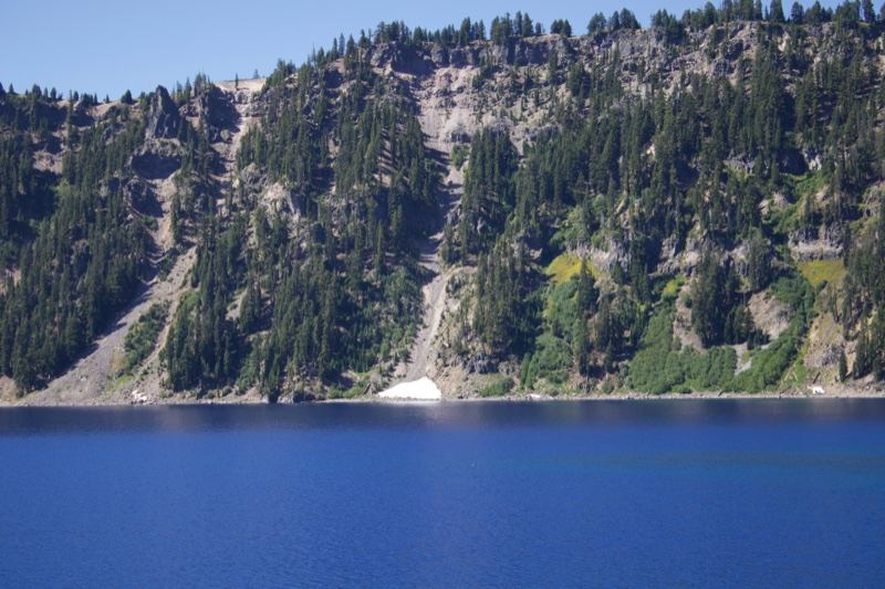 Forested Cliffs Over Deep Blue Lake