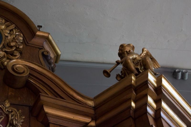 Gilded Cherub on Ornate Wood Carving