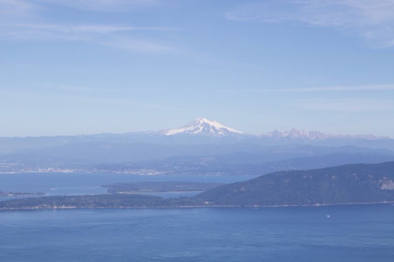 Snow-capped mountain over coastal waters