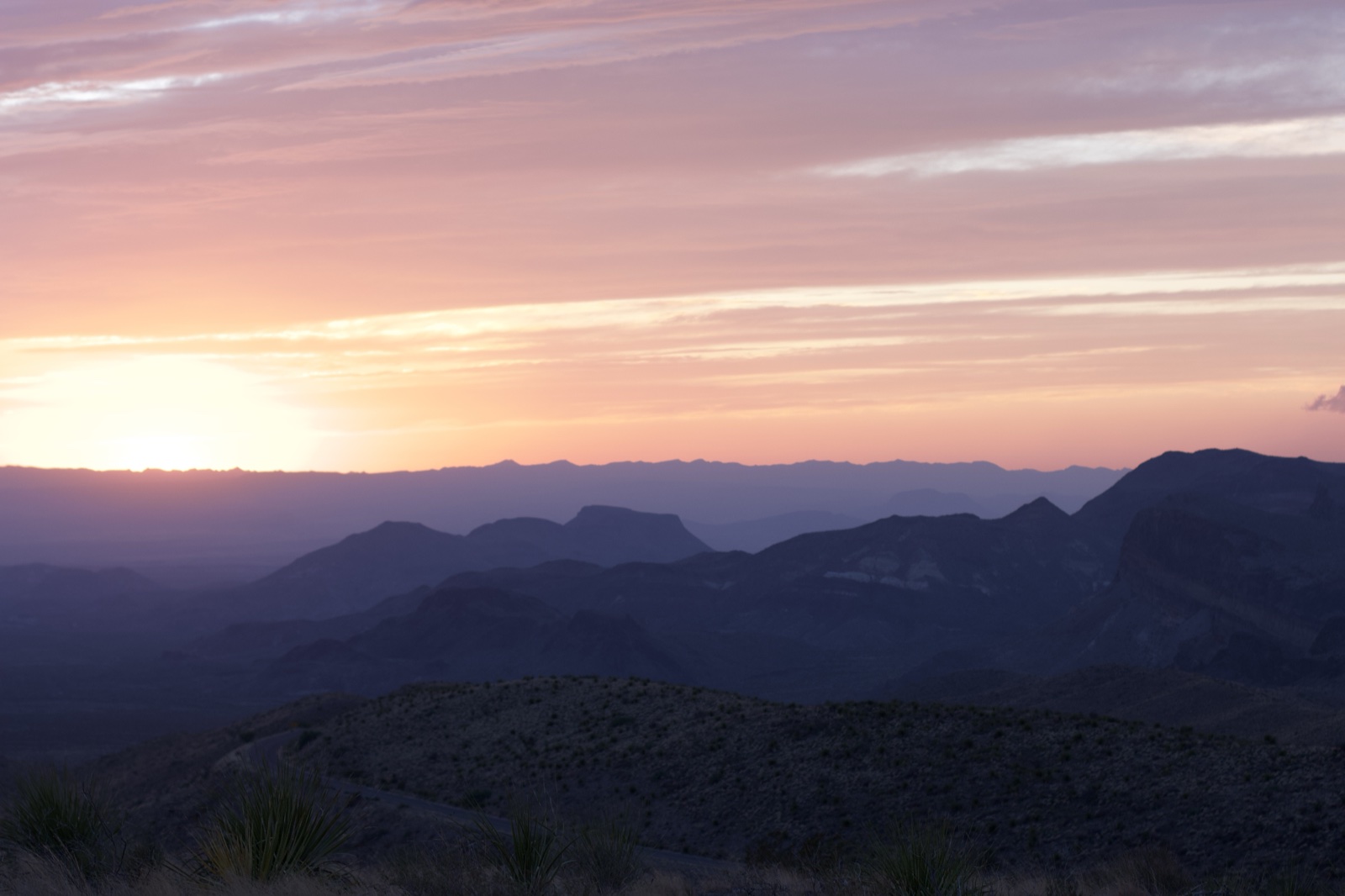Desert Sunset Over Layered Mountains