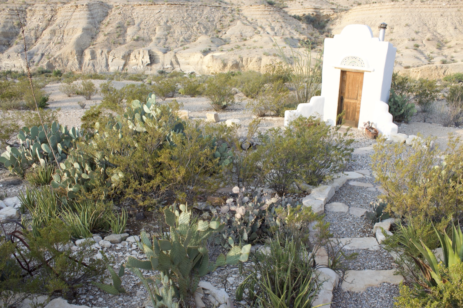 White adobe shrine in desert landscape