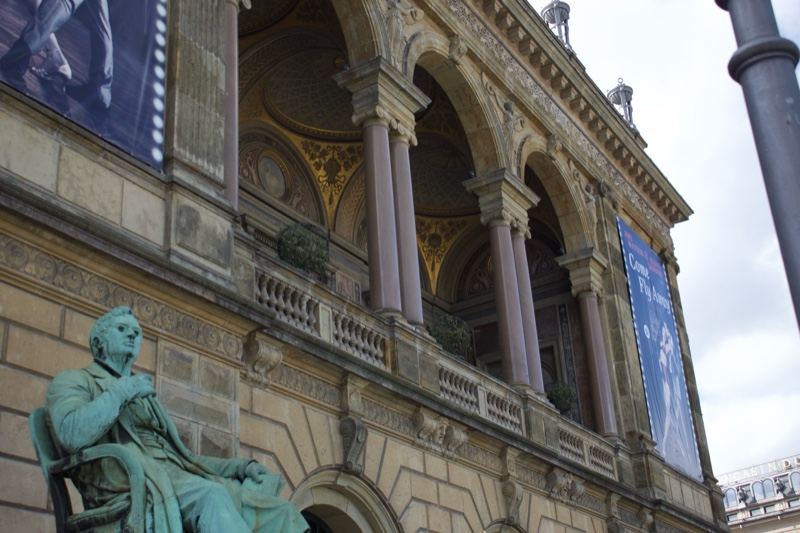 Bronze Statue Before Neoclassical Building