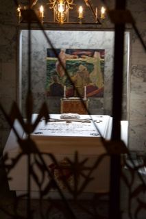 Church altar viewed through iron grille