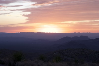 Desert Sunset Over Layered Mountains