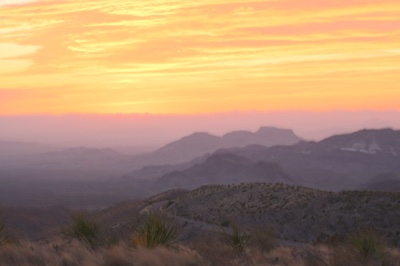 Desert Sunset Over Layered Mountains