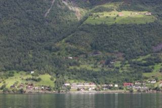 Fjord Village Beneath Forested Hills