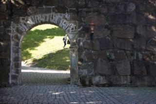 Stone Archway Leading to Grassy Lawn