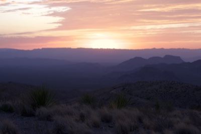 Desert Sunset Over Layered Mountains