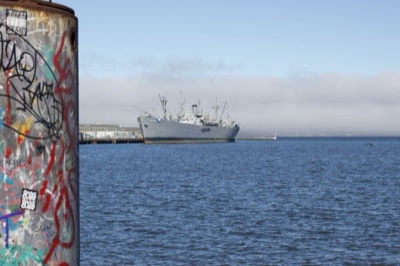 Graffiti Pillar Overlooking Harbor Ship