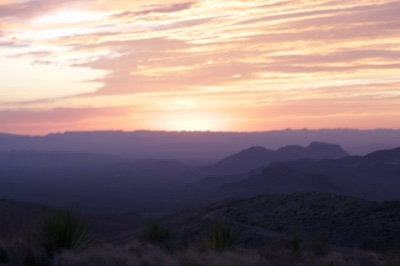 Desert Sunset Over Layered Mountains