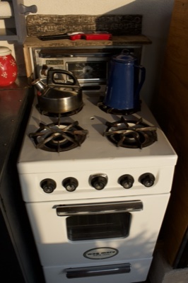 White gas stove with kettles