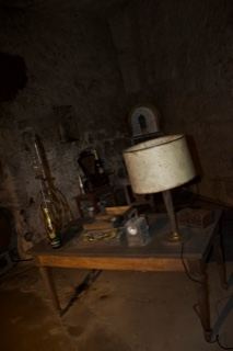 Dim Stone Room With Table Lamp