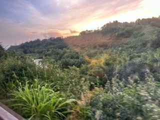 Sunset Over Lush Green Hills