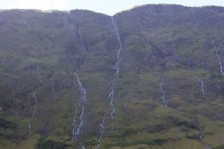 Mountain Slope With Cascading Waterfalls